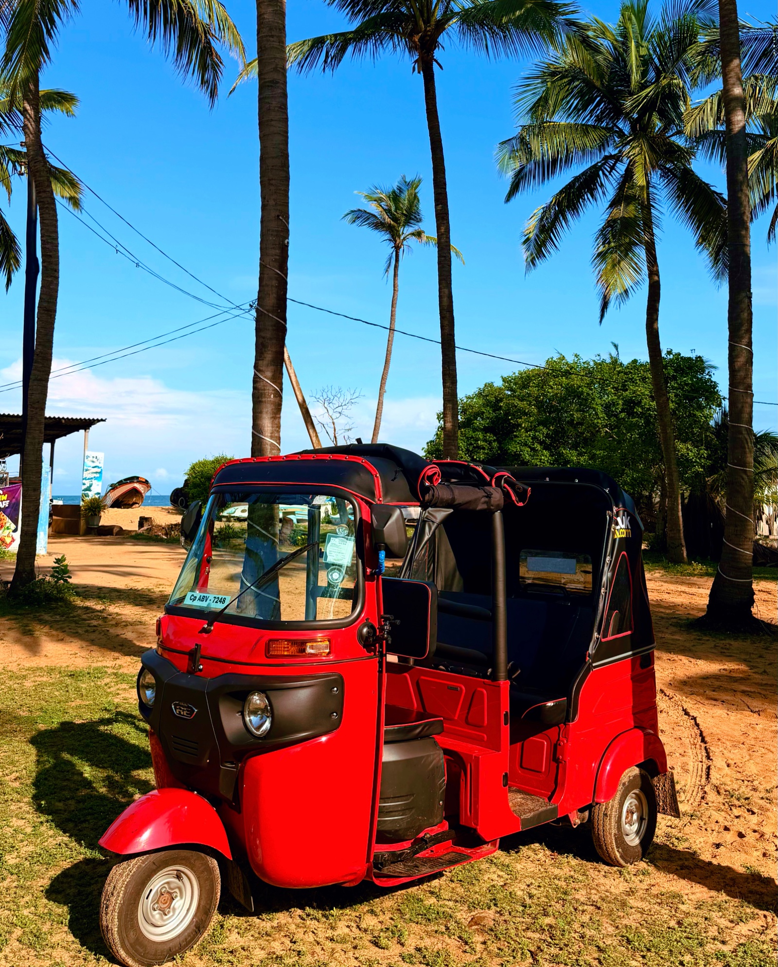 our red cabrio tuk tuk parked in Kalpitiya with the roof down