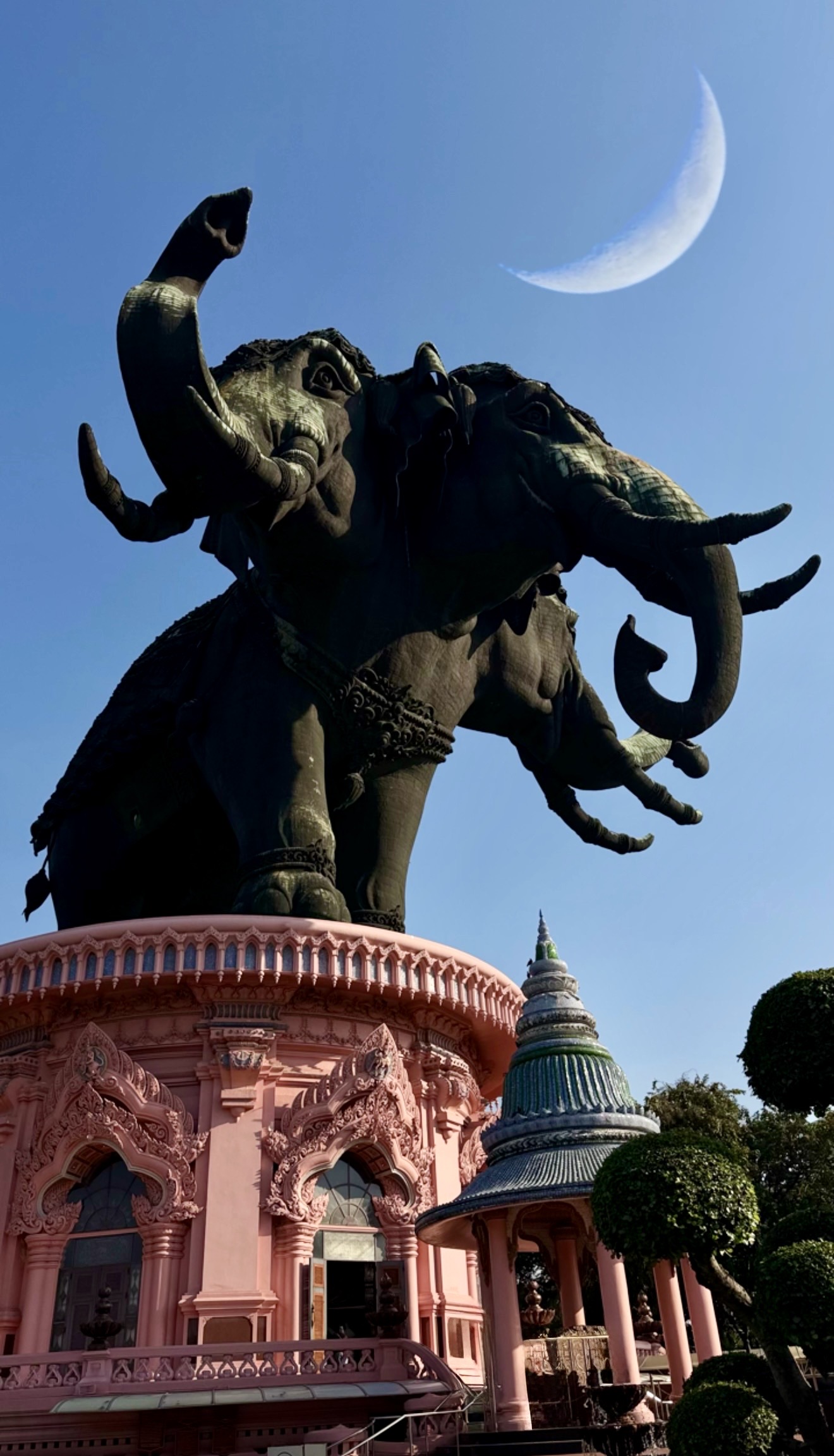 Erawan with blue sky and moon above it.